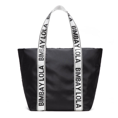 A versatile everyday tote bag designed for style and function. Made from durable lightweight nylon with bold logo shoulder straps, it’s perfect for work, travel, shopping, and daily use.