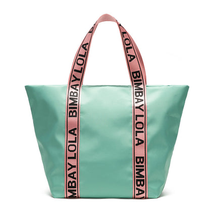 A versatile everyday tote bag designed for style and function. Made from durable lightweight nylon with bold logo shoulder straps, it’s perfect for work, travel, shopping, and daily use.