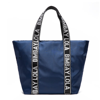 A versatile everyday tote bag designed for style and function. Made from durable lightweight nylon with bold logo shoulder straps, it’s perfect for work, travel, shopping, and daily use.