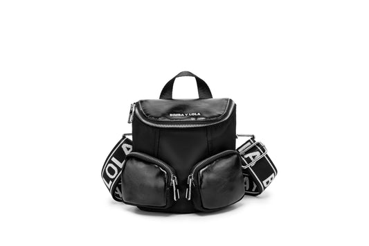 A modern mini backpack-inspired crossbody bag designed for everyday convenience. Crafted from durable black nylon with multiple front pockets and bold logo straps, it combines street-style aesthetics with practical storage