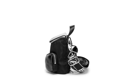 A modern mini backpack-inspired crossbody bag designed for everyday convenience. Crafted from durable black nylon with multiple front pockets and bold logo straps, it combines street-style aesthetics with practical storage
