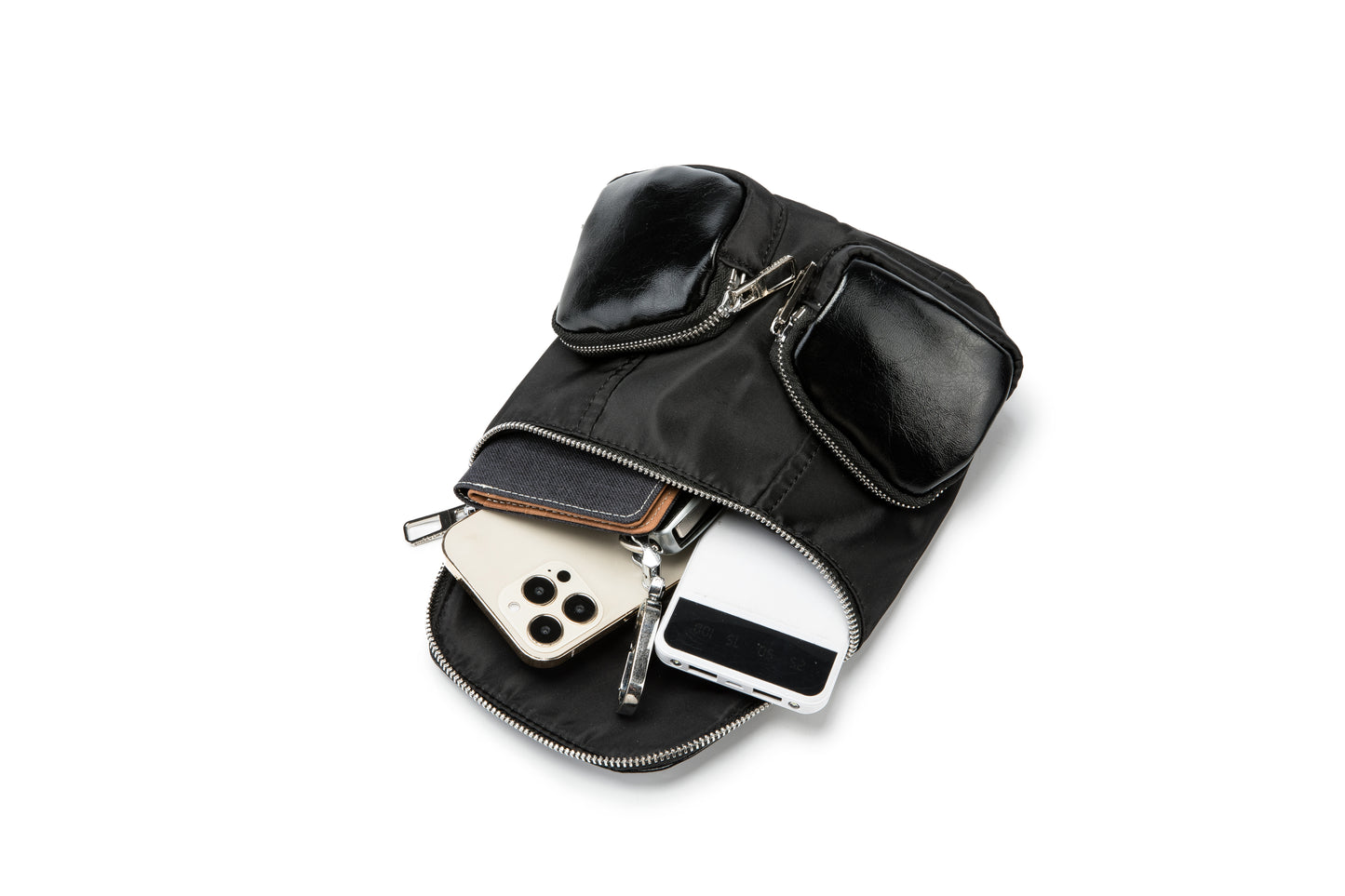A modern mini backpack-inspired crossbody bag designed for everyday convenience. Crafted from durable black nylon with multiple front pockets and bold logo straps, it combines street-style aesthetics with practical storage