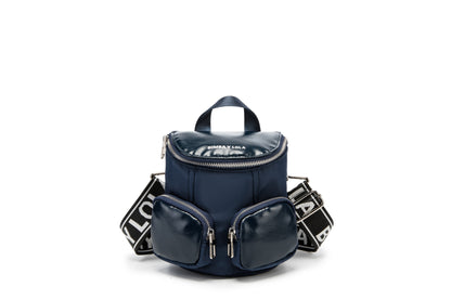 A modern mini backpack-inspired crossbody bag designed for everyday convenience. Crafted from durable black nylon with multiple front pockets and bold logo straps, it combines street-style aesthetics with practical storage