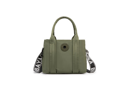 A stylish and structured mini tote designed for everyday elegance. Crafted from durable lightweight nylon in a soft lavender tone, it features dual top handles and a bold adjustable logo strap for versatile carry options
