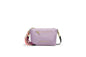 A stylish compact crossbody bag designed for everyday elegance. Featuring a lightweight nylon body in soft purple with gold-tone accents and a playful tassel strap, it’s perfect for daily outings, travel, and casual chic look