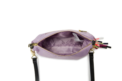 A stylish compact crossbody bag designed for everyday elegance. Featuring a lightweight nylon body in soft purple with gold-tone accents and a playful tassel strap, it’s perfect for daily outings, travel, and casual chic look